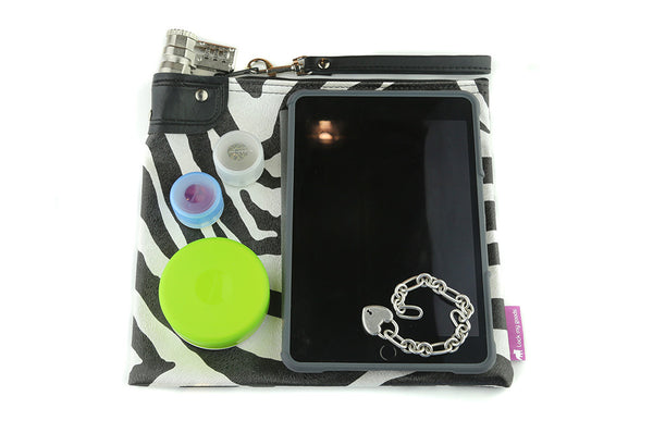 zebra print locking bag shown with mini iPad and electronics. 