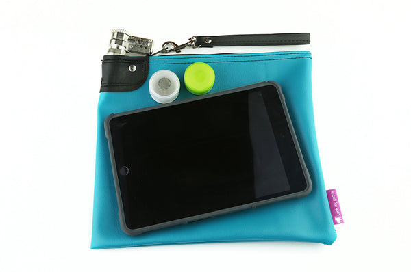 Teal prescription bag shown with mini tablet / iPad and medication. 