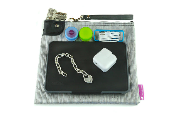 Silver, vinyl locking medication bag with combination lock, shown with mini tablet / iPad, medication and electronics. 