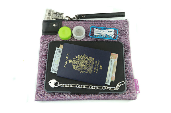 Beaded purple, rose colored money bag with combination lock and wrist strap, shown with mini tablet / iPad, passport, jewelry and medication.  