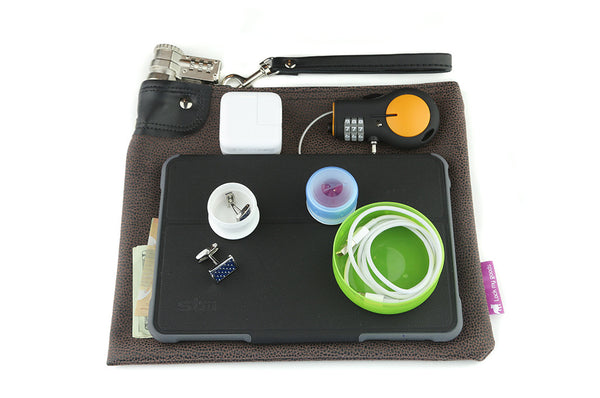 Chocolate brown, faux leather bag with Cheetah print and combination lock, shown with mini tablet / iPd, medication, retractable cable lock and jewelry. 