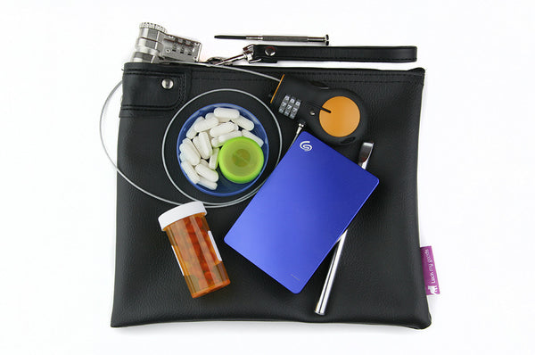 Black locking medication bag, shown with electronics and medication. Child resistant packaging for cannabis. 