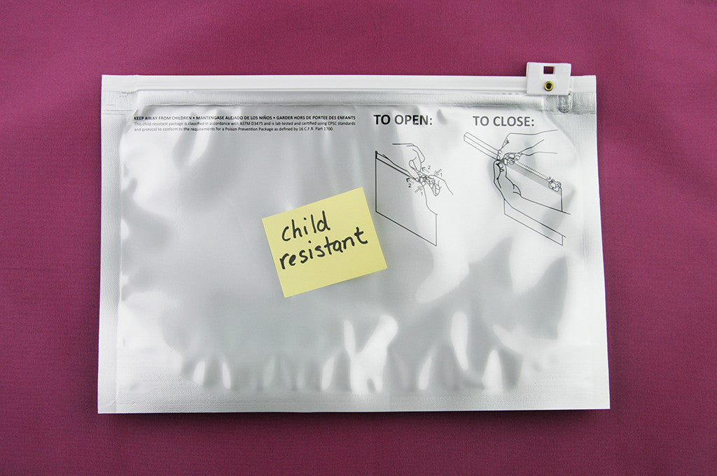 Child resistant packaging for cannabis. Stink Sack child resistant ziplock shown with cannabis edibles and oil capsules. 