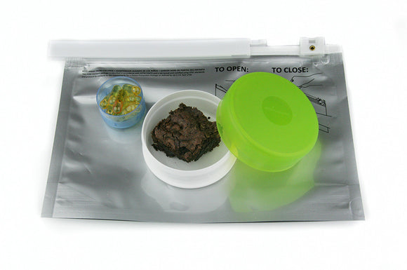 Child resistant packaging for cannabis. Stink Sack child resistant ziplock shown with cannabis edibles and oil capsules. 